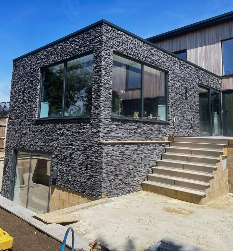 Dark graphite stone cladding on finished ground floor exterior