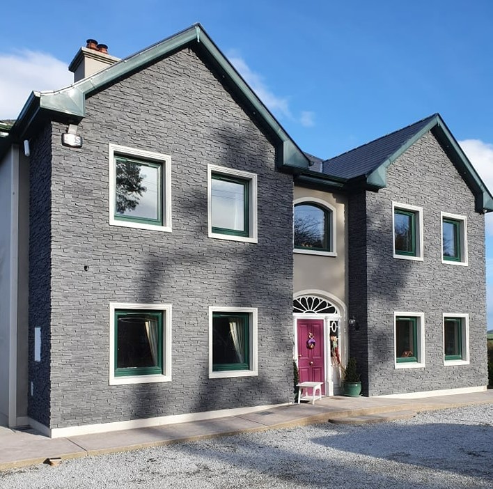 Completed exterior house renovation and stone facade transformation