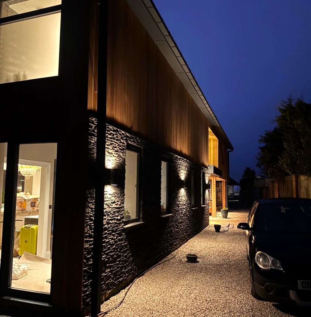 Cumbrian Slate stone cladding illuminated by exterior lighting at night