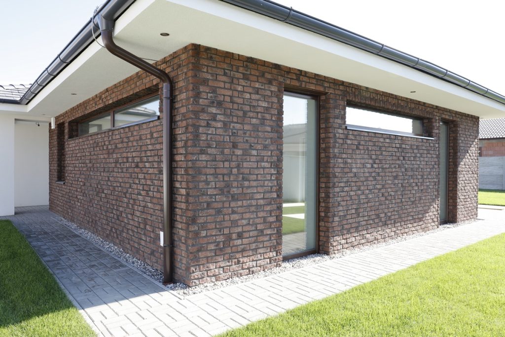 Brick slip installation on residential property exterior